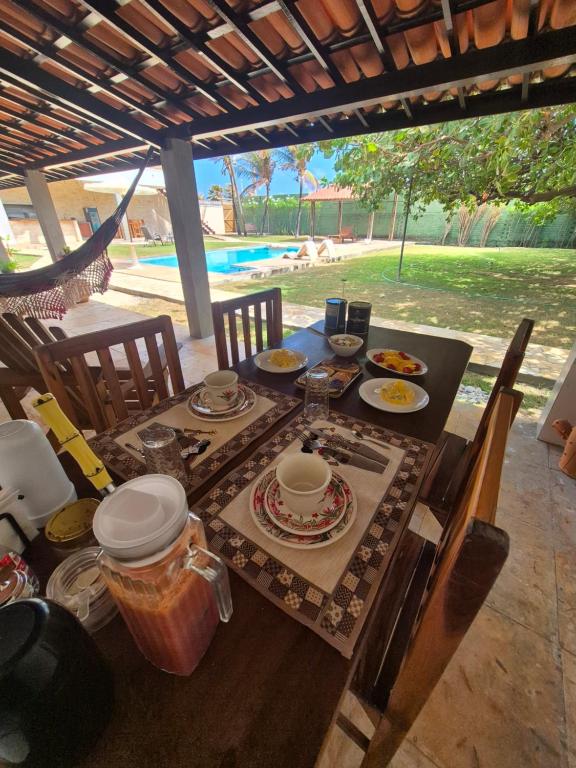 a wooden table with food on top of it at Biruta's Beach House - Taíba in São Gonçalo do Amarante