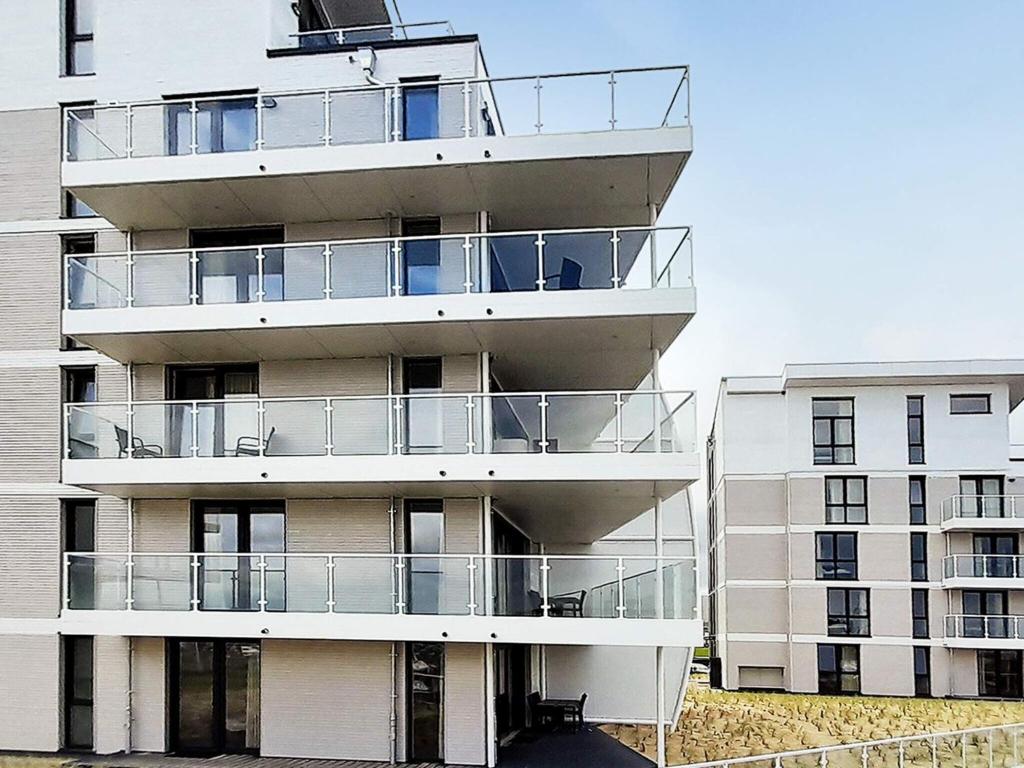 an apartment building with balconies on the side of it at Luxusurlaub direkt an der Ostsee in Wendtorf