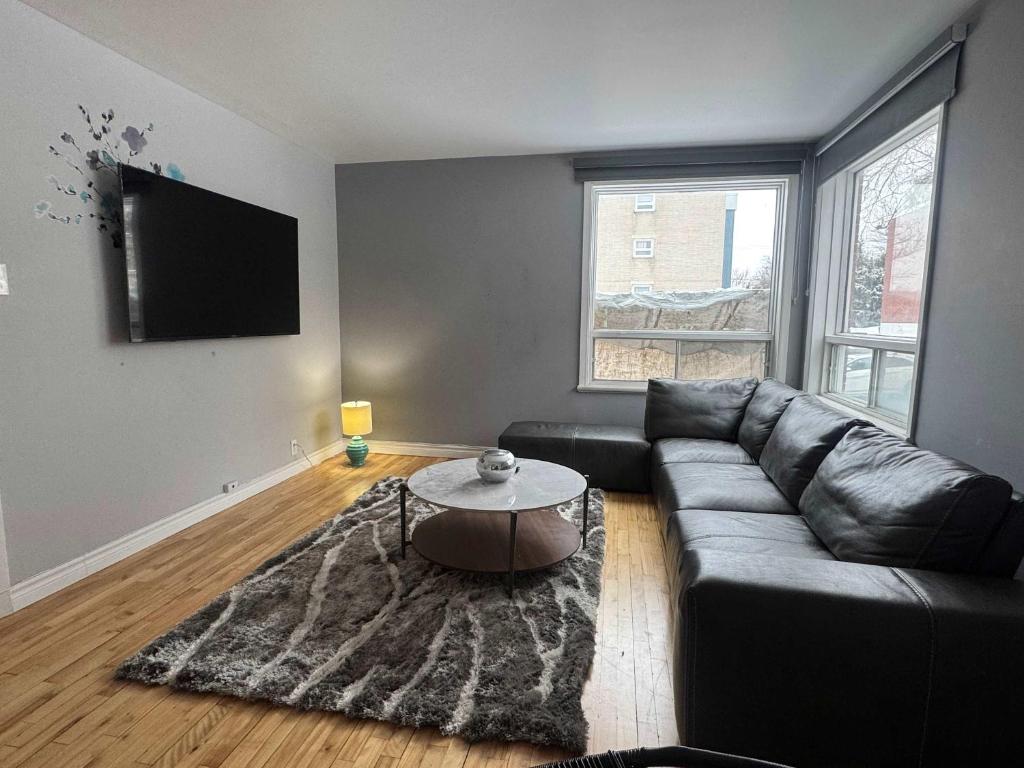 a living room with a couch and a table at Condo ville de quebec in Quebec City
