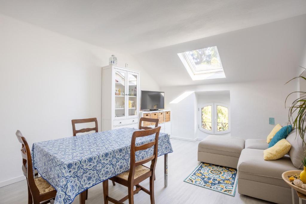 a living room with a table and a couch at Elegante Attico Fronte Lago - Casa Barozzi in Luino