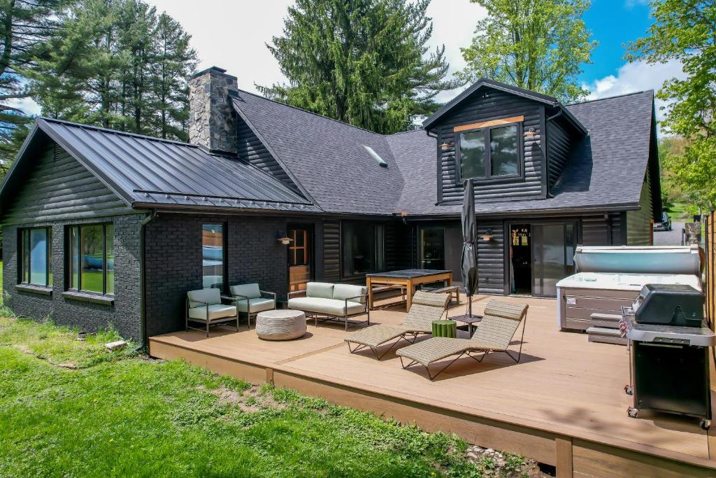 a house with a deck with a grill at Modern Stunning Private Flat Lakefront in Oakland