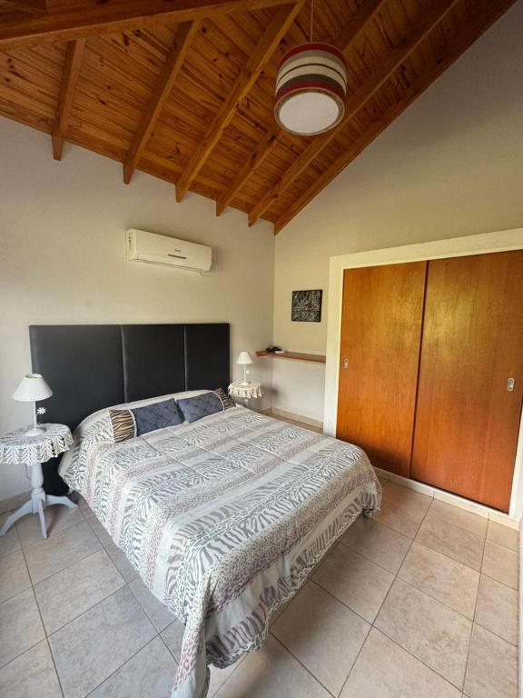 a bedroom with a large bed and a wooden ceiling at San Luis Aparts in Carpintería
