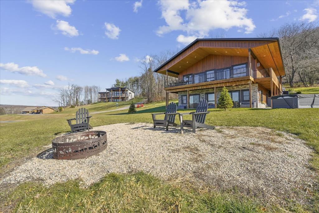 a house with two chairs and a fire pit in front of it at THE VIEW Hot Tub Fire Pit Private in McHenry