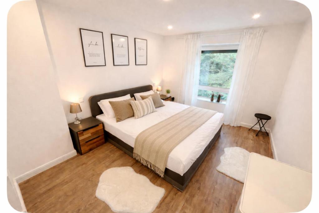 a bedroom with a large bed and a window at Apartment Heide in Soltau