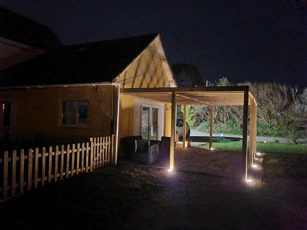 a house with a pavilion in the yard at night at The Station Masters Lodge in Hayle