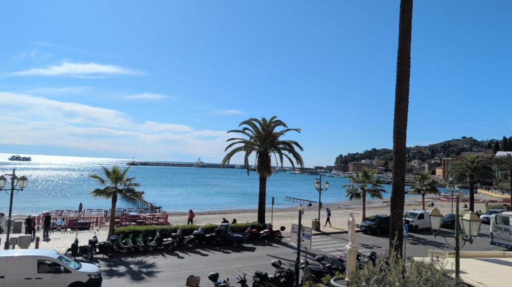 a view of a beach with palm trees and the ocean at Due balconcini sul mare in Santa Margherita Ligure