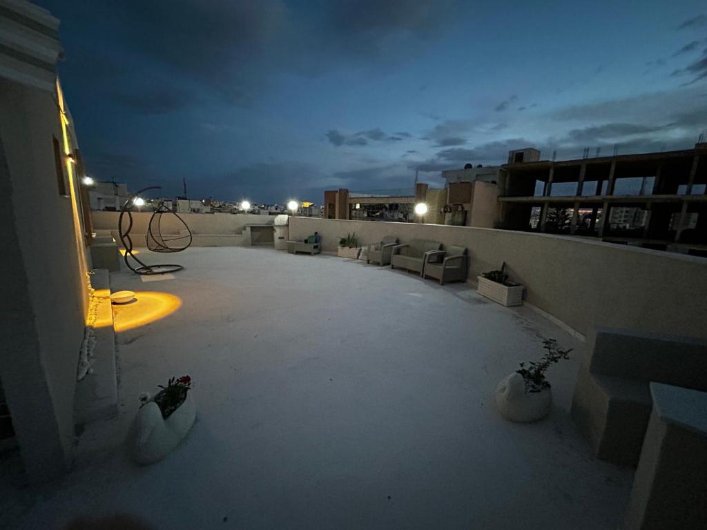 a view of a rooftop of a building at night at Sea View 1 Bedroom Apartment with 100m Terrace in Sousse