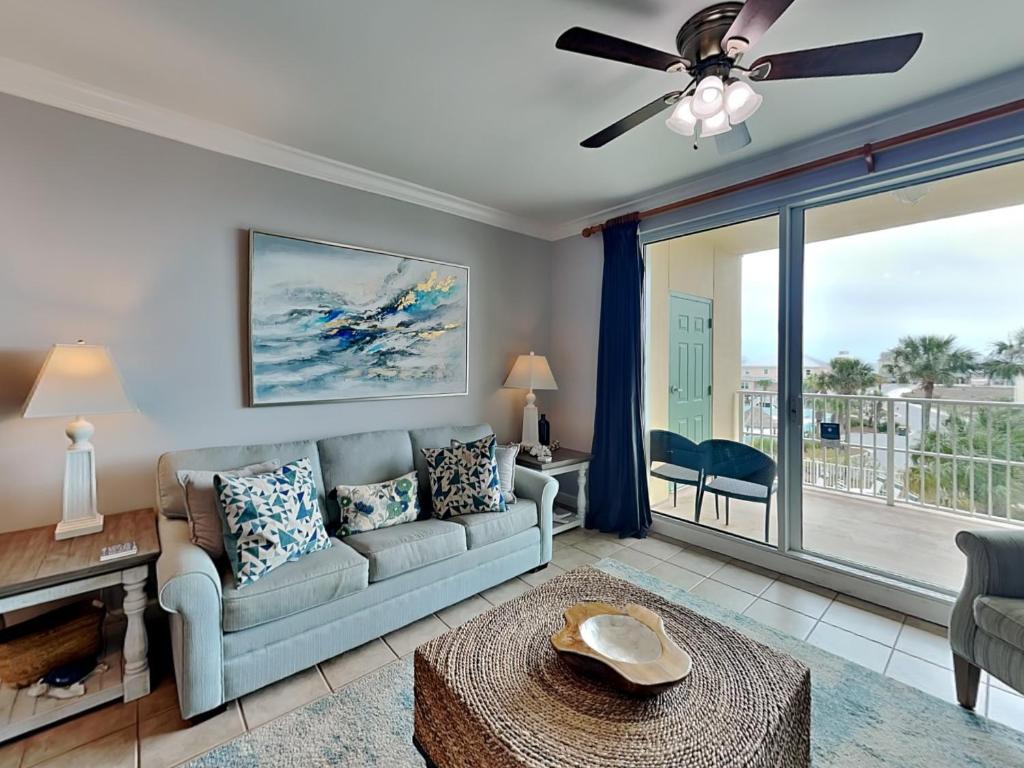 a living room with a couch and a ceiling fan at The Indies #209 in Fort Morgan