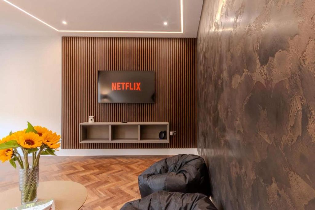 a living room with a television on a wall at Luxury Seaside Home, Sleeps 6 in Broadstairs