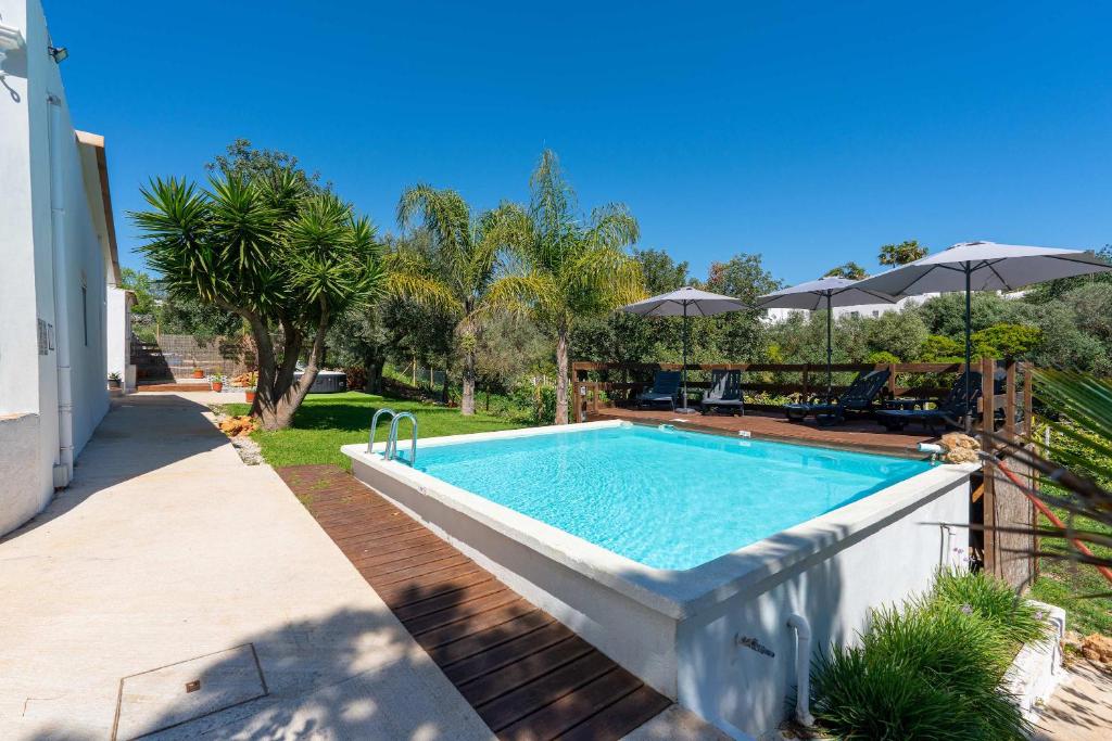 a swimming pool in the backyard of a house at Spacious & Artistic House with Pool by HostWise in Moncarapacho