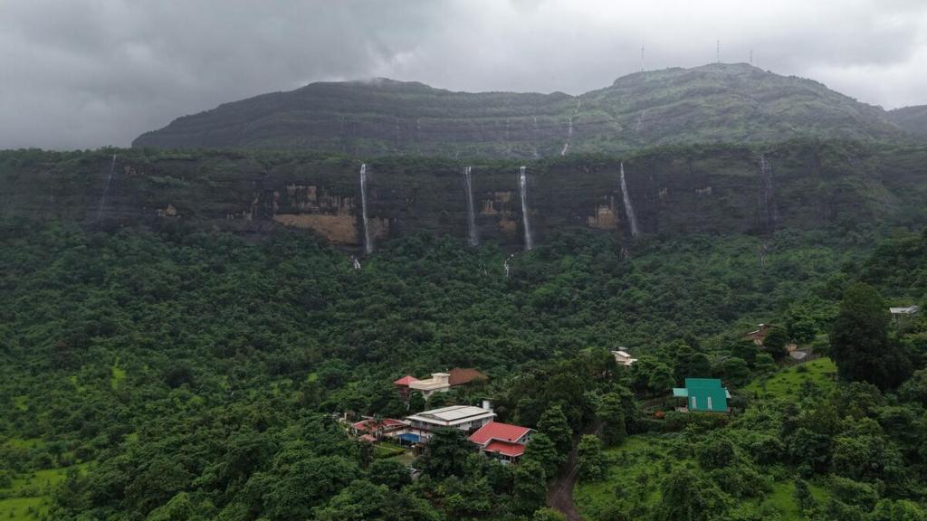 an aerial view of a mountain with waterfalls at Misty Falls Karjat Waterfall view in Jambrung 