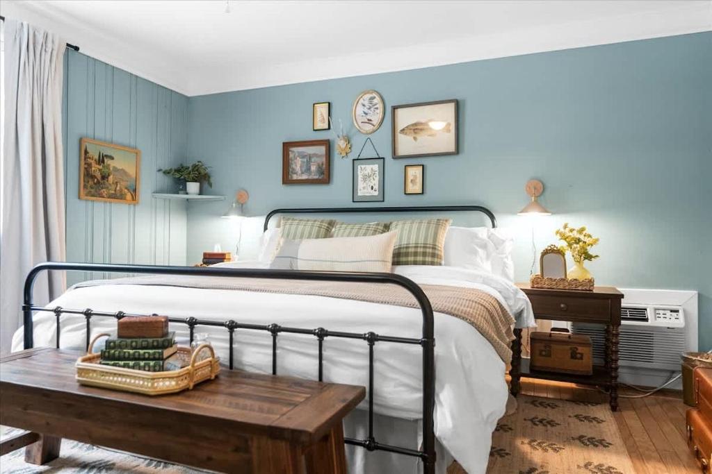 a bedroom with blue walls and a bed with a wooden table at 7- Rock Island Cottage in Lookout Mountain