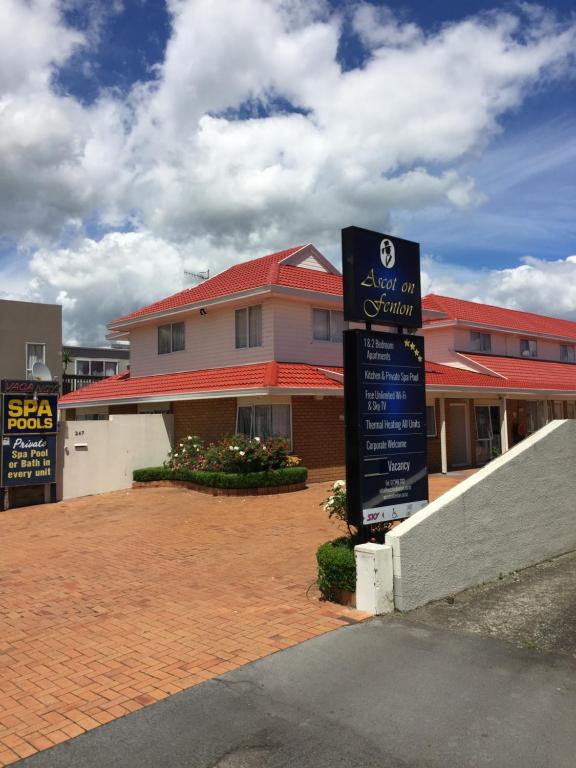 a sign in front of a school with a building at Ascot On Fenton in Rotorua