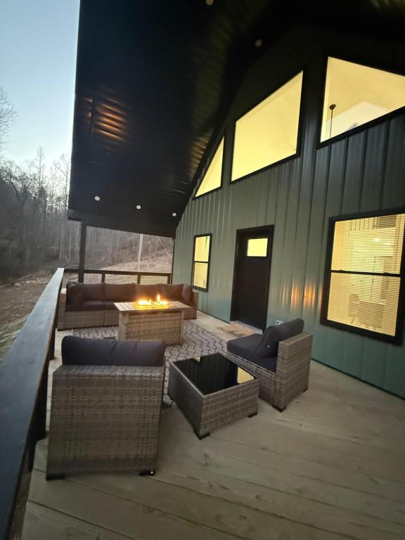 a patio with couches and a fire pit on a building at Sandstone Lodge in Stanton