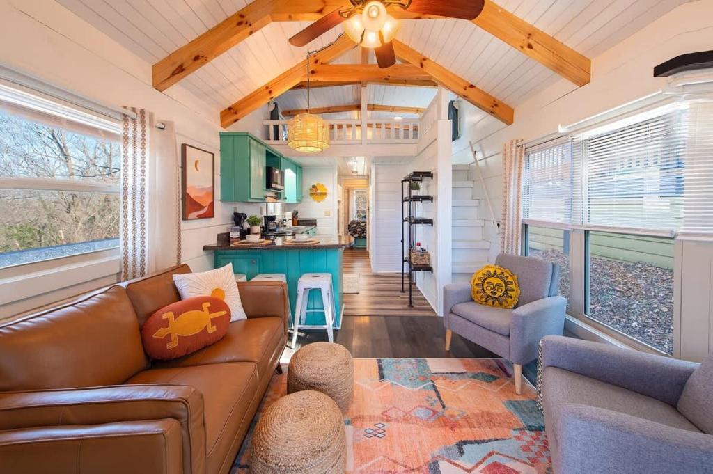 a living room with a couch and a kitchen at Sophie Cabin National Forest Tiny Cabin in Chattanooga