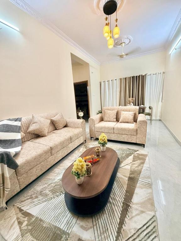 a living room with a couch and a coffee table at Elite Apartment in Hyderabad