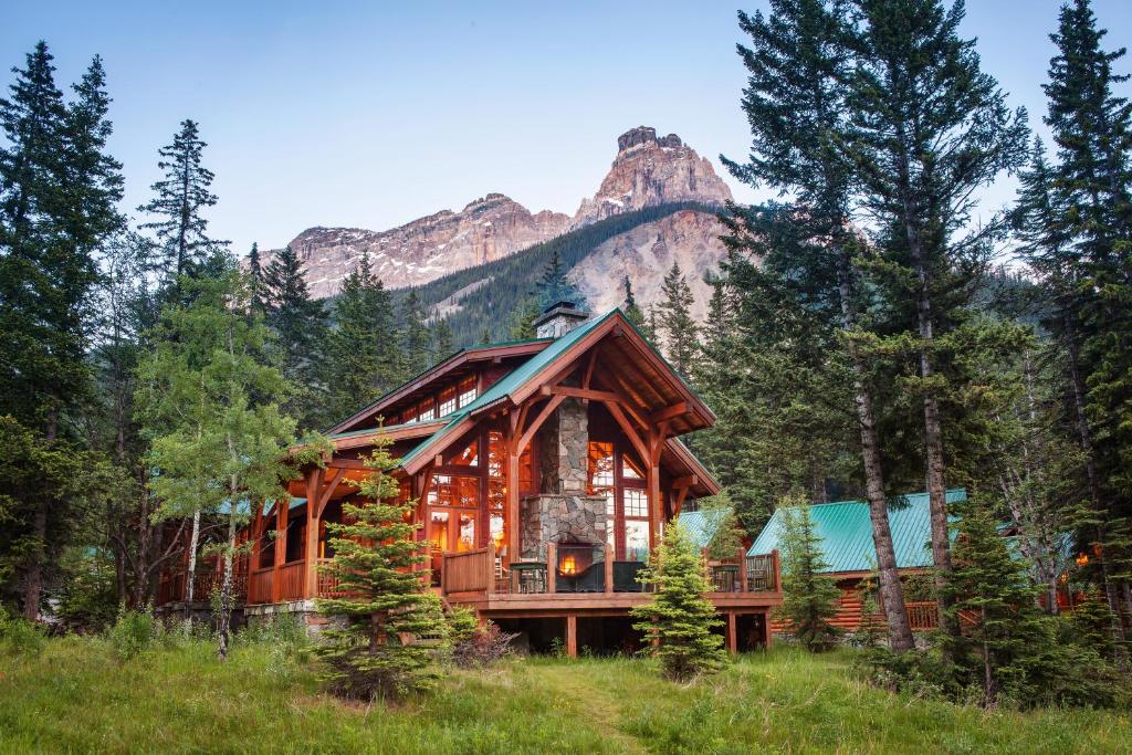 a large wooden cabin with a view of a mountain range at Cathedral Mountain Lodge in Field