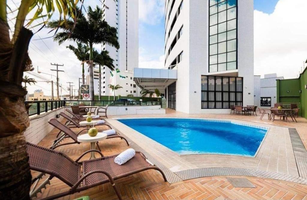a pool on the roof of a building at Plaza Suíte Natal Vista Mar in Natal