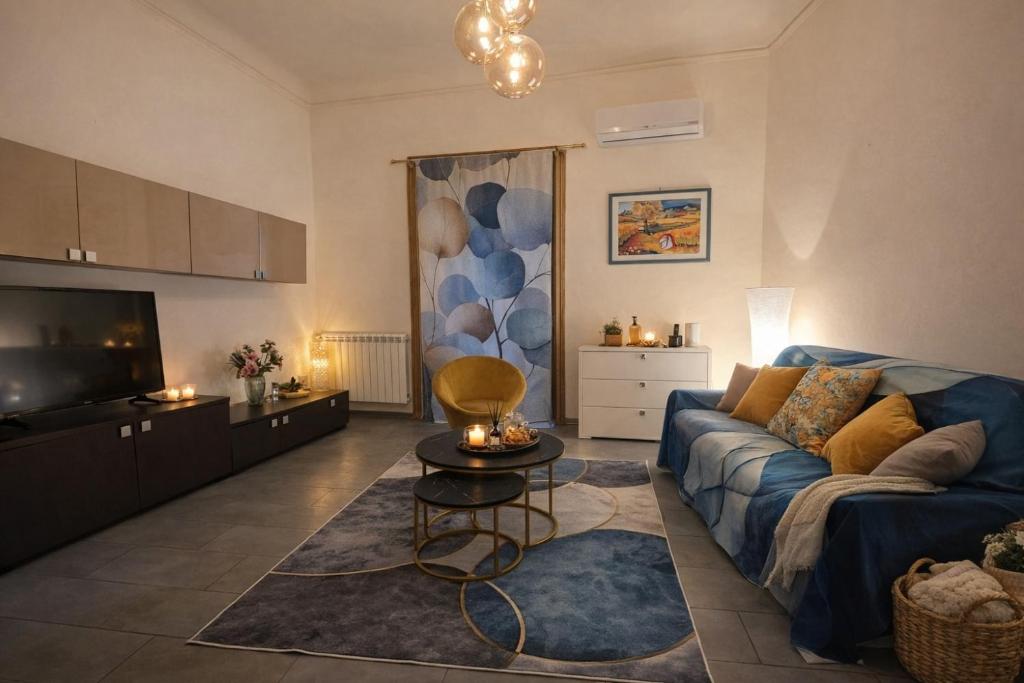 a living room with a couch and a tv at Al Piccolo Cassaro in Caltanissetta