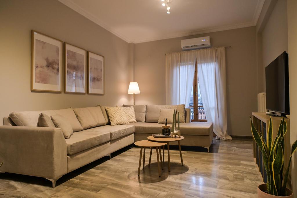 a living room with a couch and a tv at Central Boutique Apartment Gythio in Gythio