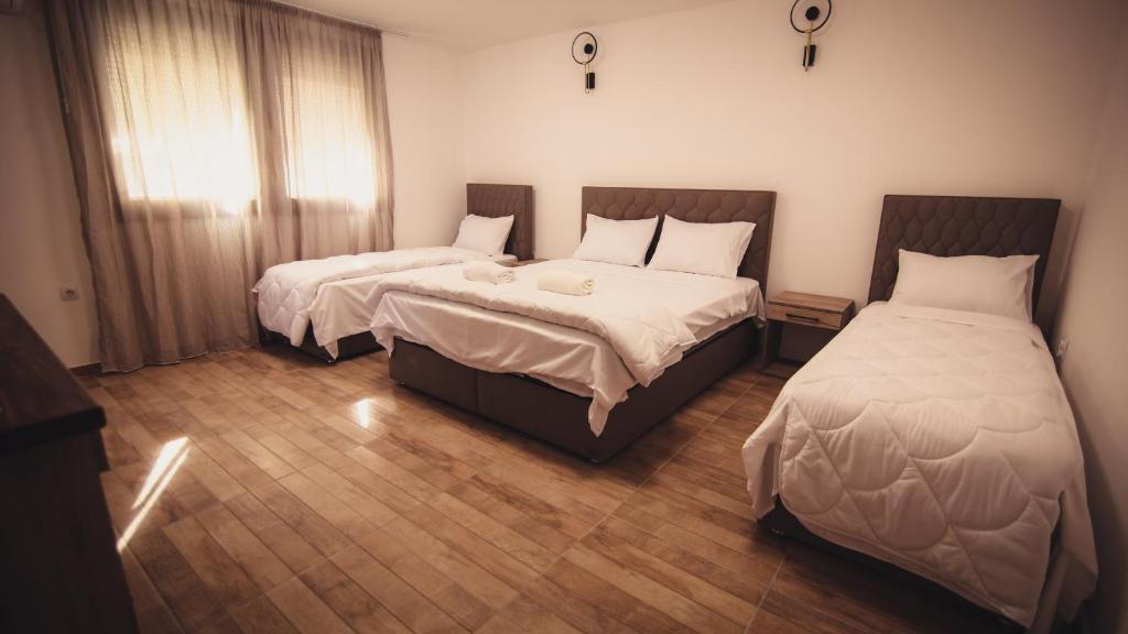 a bedroom with two beds and a window at Saint Sava in Ohrid