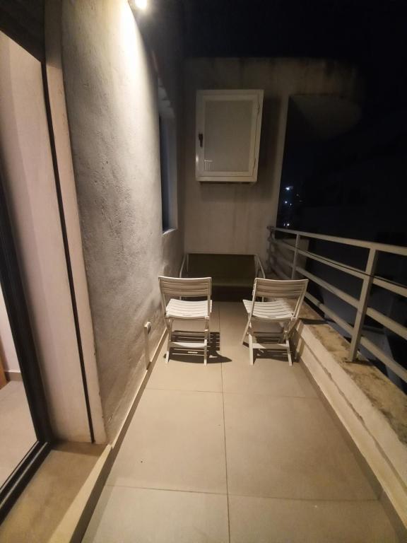 two chairs sitting in a room with a wall at Princess Mayfer in Maarif