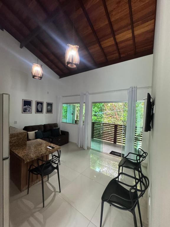 a living room with a couch and a table and chairs at Flat Bluvi Centro de Barra-Grande in Marau