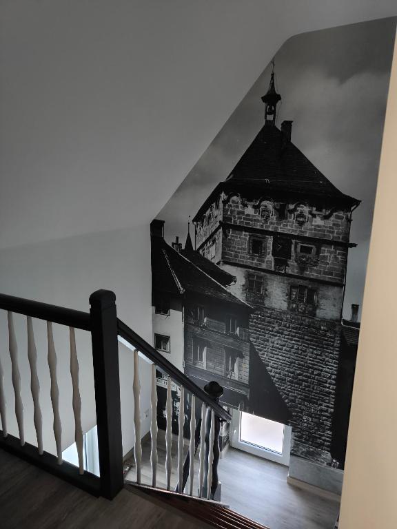 a stairway with a picture of a tall building at Ferienwohnung Kampić Turmblick in Rottweil