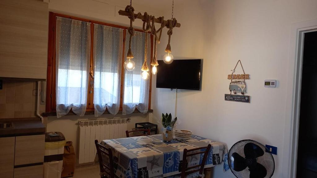 a dining room with a table and a television at Appartamento bilocale in Cecina