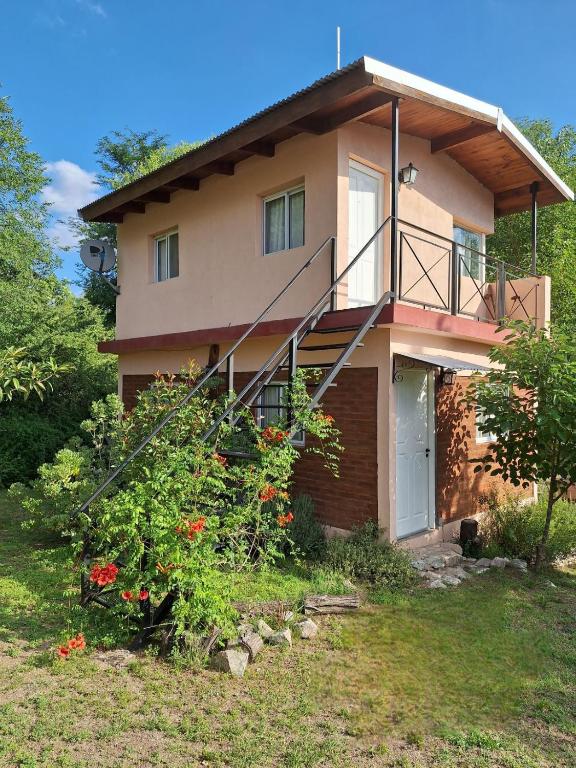 a house with a staircase in front of it at Cabañas Tinku del Sol in Casa Grande
