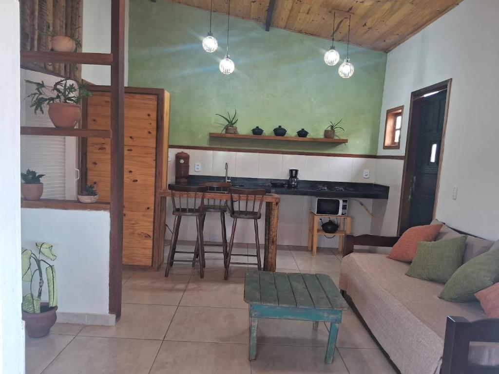 a living room with a couch and a table at Cozy, rustic apartment with balcony in Búzios