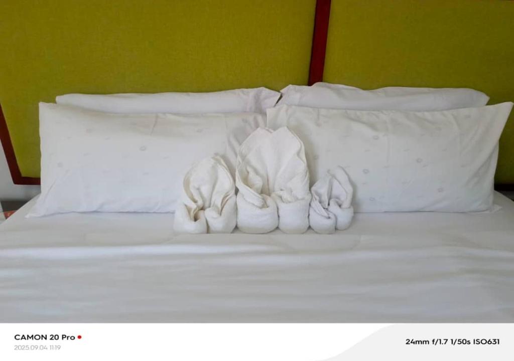 a group of white shoes sitting on a bed at Raneziah Guesthouse in Kasane