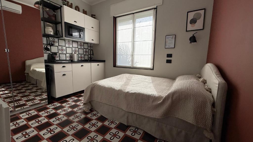a bedroom with a bed and a window in it at Design studio Margherita in Cinisello Balsamo