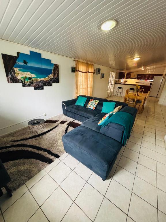 a living room with a couch and a table at Sermie T4 à kourou avec piscine in Kourou