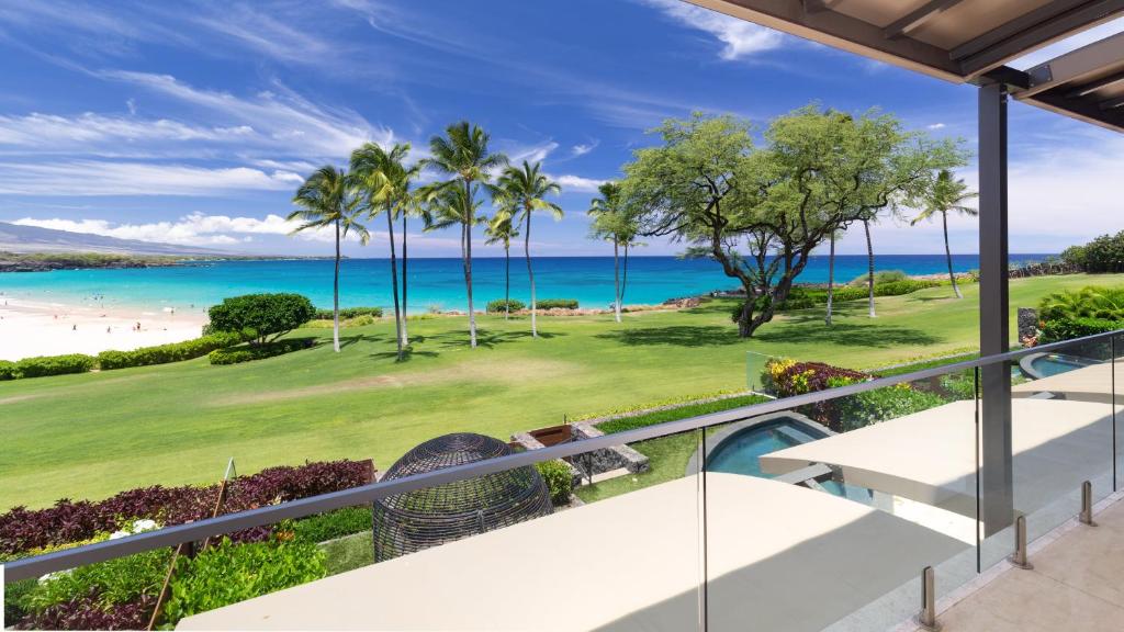 an oceanfront balcony with a view of the beach at ❤PiH❤ Hapuna Surfside Beachfront Steps From Ocean B26 in Hapuna Beach