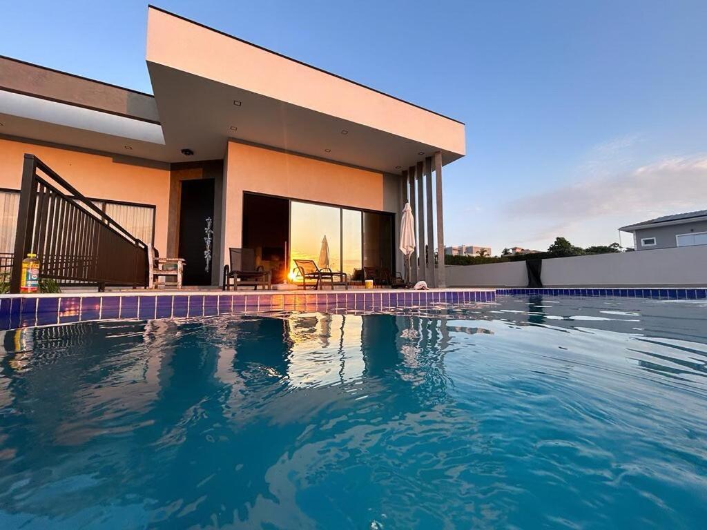 a large swimming pool in front of a house at Cantinho Solis in Itupeva