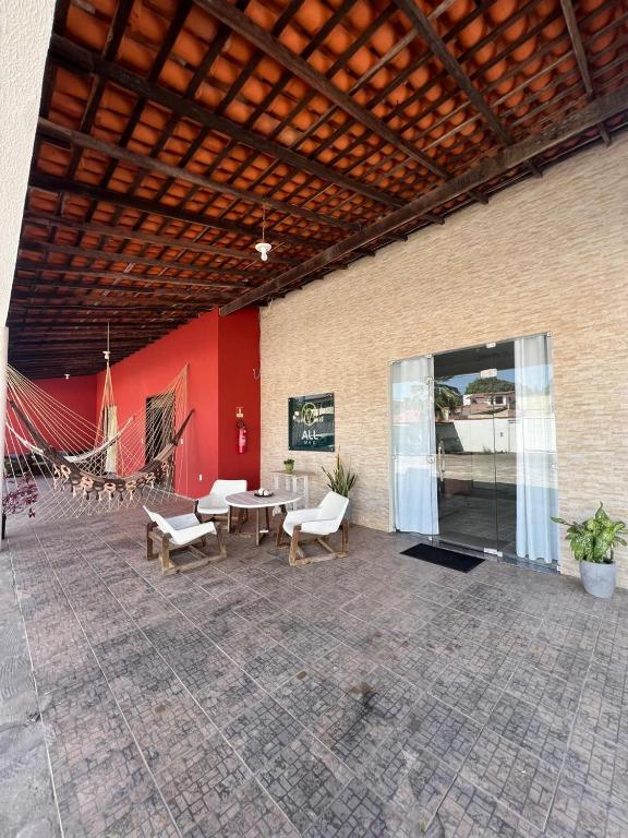 a patio with tables and chairs in a building at Allmedhouse in São Luís