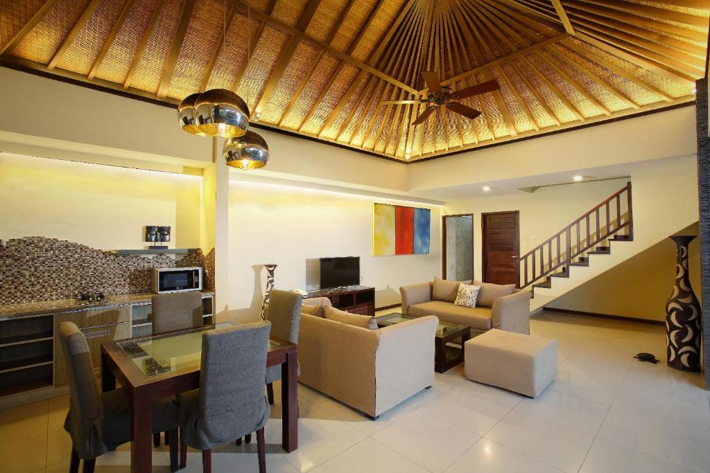 a living room with a couch and a table at Lalasa Villas Canggu in Canggu