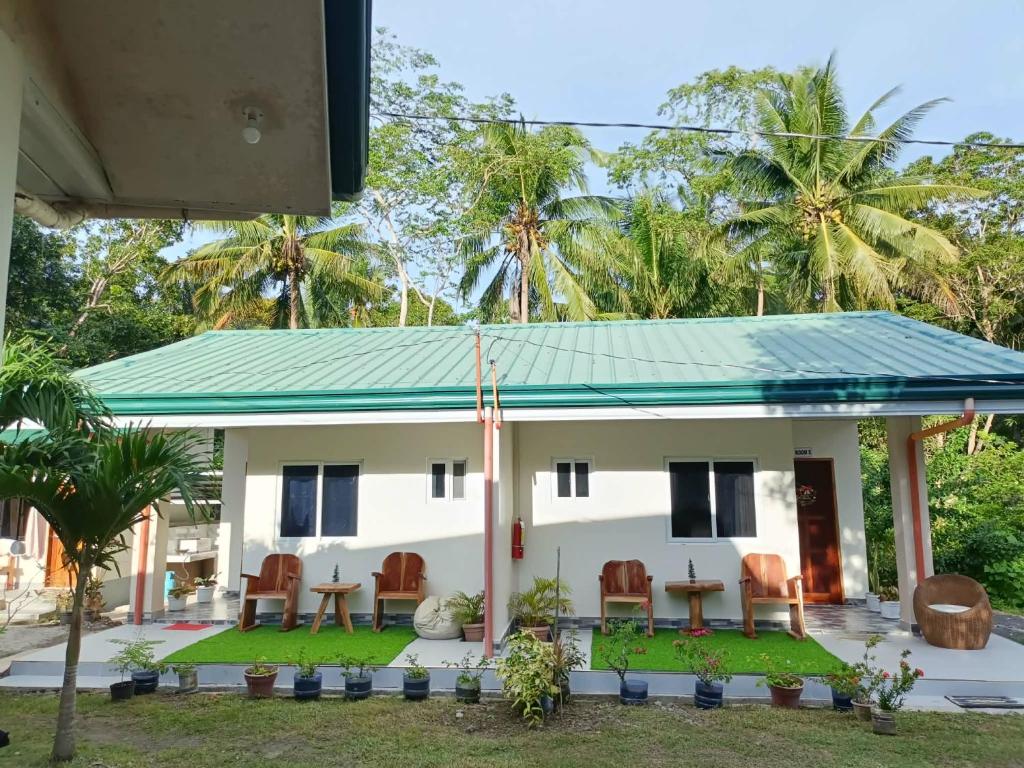 a house with a green roof at Room 5 in Siquijor