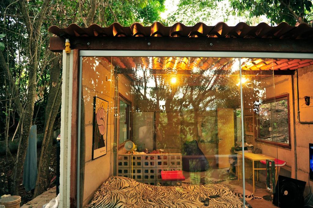 a window of a house with a table in it at Casinha Natureza in Brasília