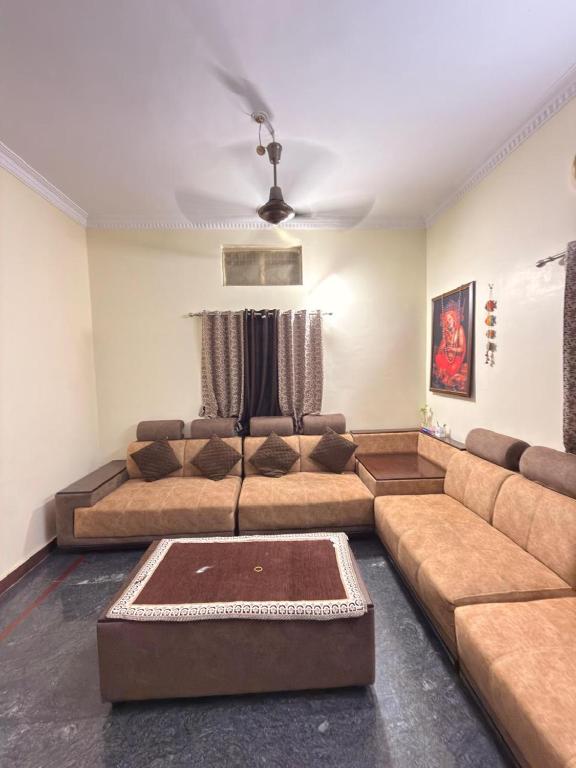 a living room with a couch and a ceiling at Simba Stay's 2BHK 1 in Chikmagalūr
