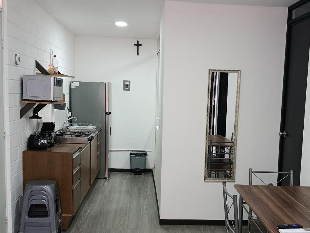 a kitchen with a sink and a refrigerator at Depa Risalud! in Santa Cruz Huatulco