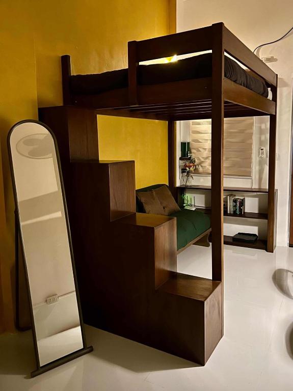 a bunk bed in a room with a mirror at Baler Modern Studio Loft Haven in Baler