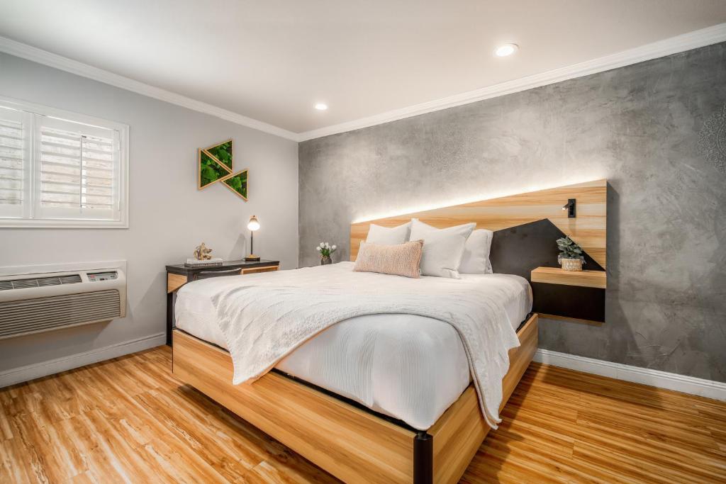 a bedroom with a large bed and a window at The Beverly House by AGA - Beverly Hills in Los Angeles