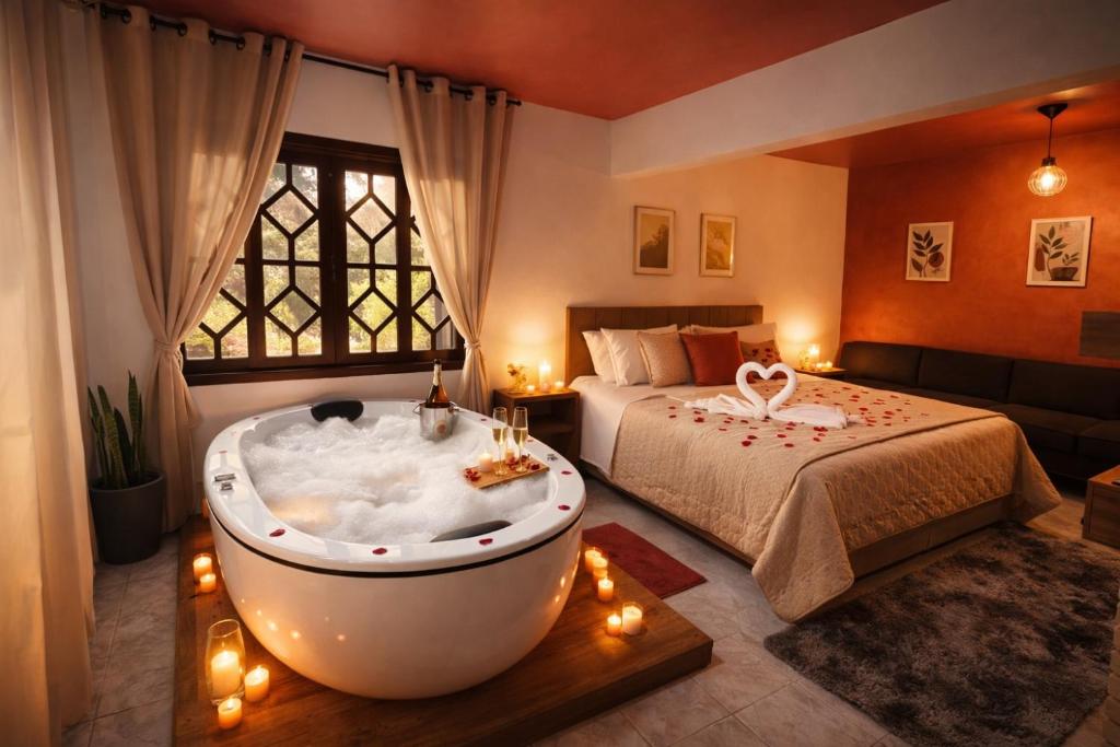 a bedroom with a bed and a tub in a room at Villaggio Farnese in Campos do Jordão