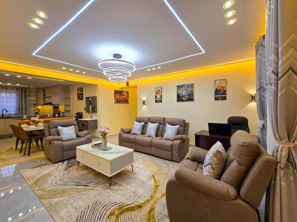 a large living room with couches and a table at Monte Opulent Haven in Eldoret