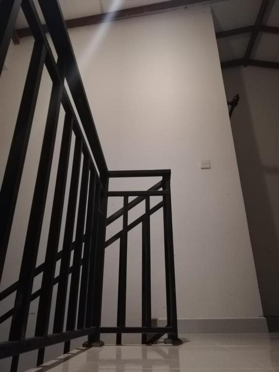 a staircase in a room with a white wall at Meegoda Villa in Kalutara