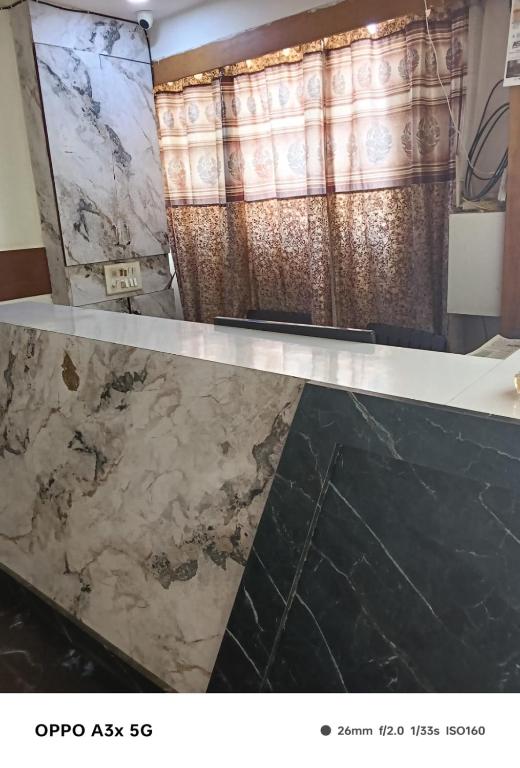 a marble counter top in a bathroom with a shower at Hotel Vinayak Naroda in Ahmedabad