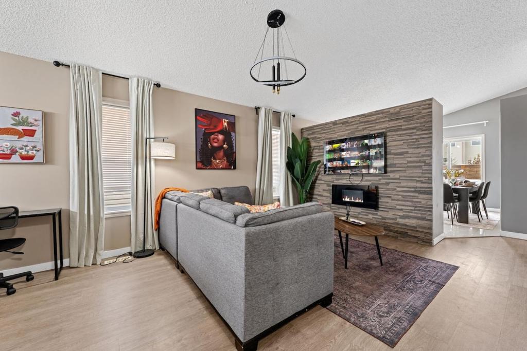 a living room with a couch and a fireplace at 5BR Wild Rose- Meadows, AC, Garage, Sleeps 12 in Edmonton