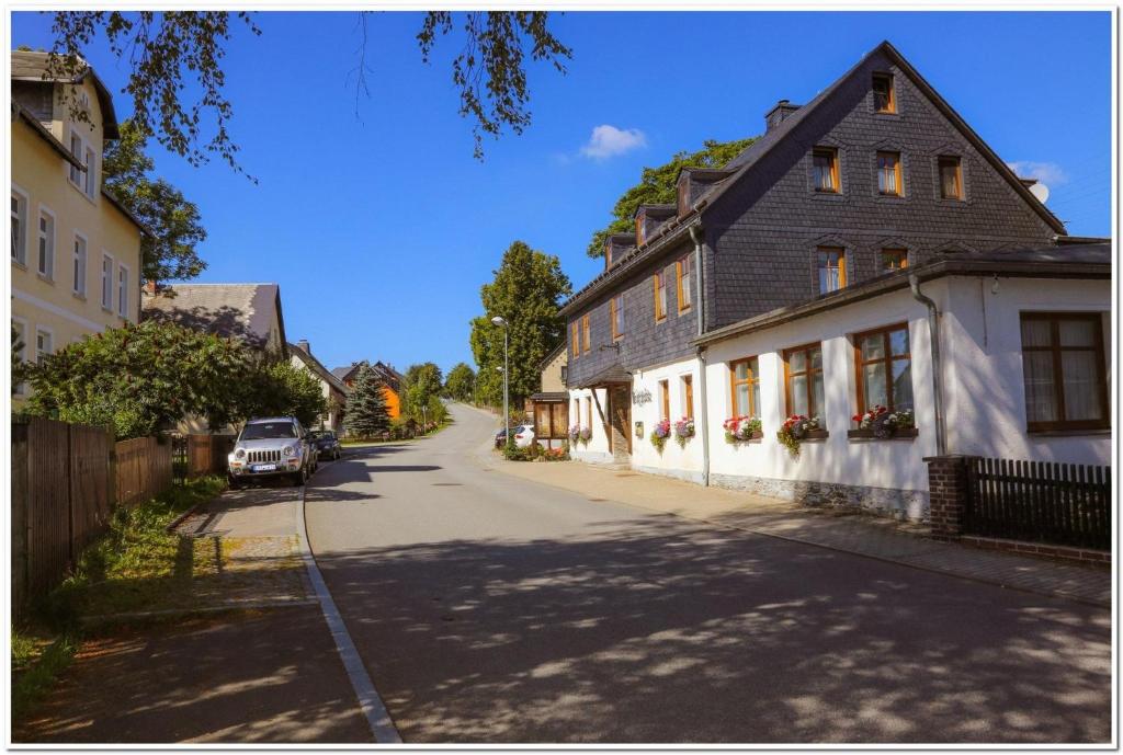 an empty street in a small town with houses at Pension Teichschänke in Zwönitz